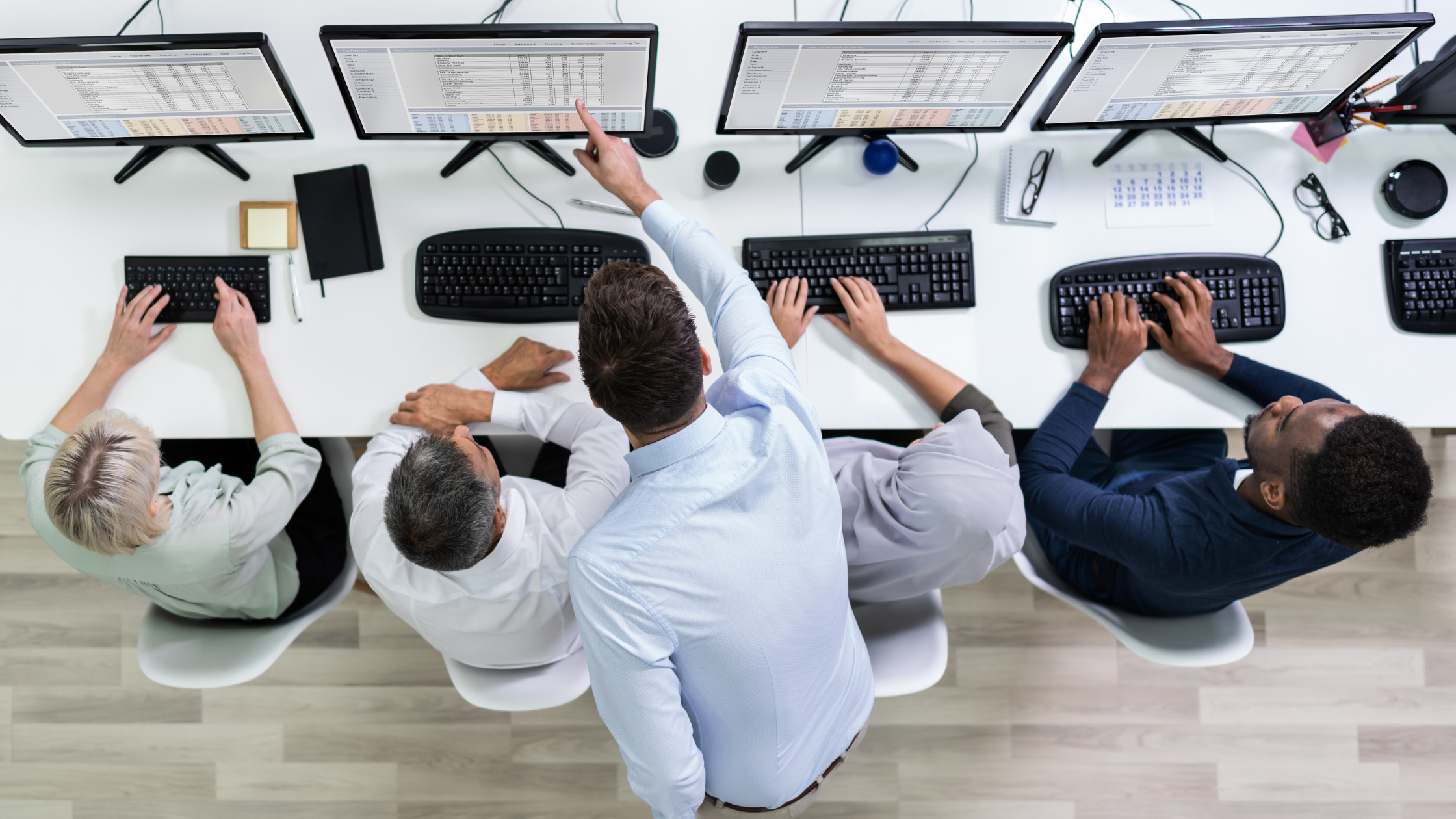 Birds eye view of a team being trained on computers